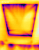 The dark purple lines and streaks around the attic access hatch and along the wall top plate in this infrared camera image indicate air leakage that could be fixed with weather stripping around the access hatch and spray foam over the top plate 