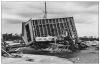Continuous load path failure due to improper connections between a home and its foundation allowed this building to be overturned in hurricane force winds.