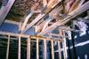 Where the interior wall intersects the corridor wall in this multifamily building, the first intersecting wall stud is sealed to the corridor wall along both sides; other seams and penetrations in the exterior wall are also sealed