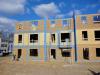 All of the sheathing seams and joints in the exterior walls of this multifamily building are air sealed with tape including the seams at the party wall interfaces