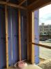 Wrong - Membrane or sealant air seal is missing at the intersection of the party wall with the exterior wall in this multifamily building 