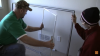 Typically, you will remove the glass panels from the frame before installation; check the manufacturer’s instructions.