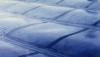 Wrong – This roof membrane on a low slope roof is fluttering and may fail because it is not fully adhered and deck seams below are not sealed, allowing air to leak up into the assembly while the membrane is pulled up due to negative pressures from wind