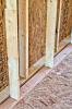 This home’s double-wall structure consists of two 2x4 walls set two inches apart, then sheathed on the exterior and netted on the interior to create a 9.5-inch wall cavity that is filled with blown fiberglass insulation.