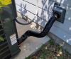 The refrigerant line for this outdoor compressor unit of the home’s air conditioner is covered  with new pipe insulation then wrapped with an additional UV-resistant jacket to protect it from the elements.