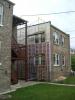 In this exterior wall retrofit of a masonry brick home, first the brick was covered with a fluid-applied water and air control layer (white), then 2x4 furring strips and two layers of rigid foam insulation, then 1x4 furring strips to attach cladding to