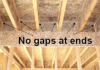 Gaps between garage and conditioned space are properly sealed by carefully cutting and then caulking wood sections to fit between trusses above shared walls.