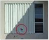 Residential glazing in wind-borne debris regions is required to resist test missile C or D; however, field investigations have shown that roof tile can penetrate shutters that comply with test missile D like this one, so test missile E compliant shutters are recommended near homes with tile roofs in wind-borne debris regions. 