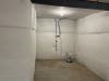 Right - The blanket fiberglass insulation is installed over a continuous layer of rigid foam insulation; the fiberglass is covered with a vapor retarder that is tape sealed at the seams.