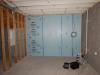 Right - XPS rigid foam board is tightly installed against a concrete foundation wall and seams are sealed with tape prior to installing fibrous blanket insulation.