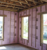 Masonry walls can be insulated with rigid foam insulation attached to the interior face of the concrete block as shown here.