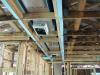The main trunk line of the ducts runs within an insulated duct chase installed in a notch designed into the roof trusses that runs the length of the home to provide supply air directly to most of the home’s ceiling registers.