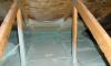 Spray foam insulates and air-seals the ceiling deck and top plates of this vented attic.
