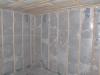 Blown cellulose insulation completely fills the netted wall and ceiling cavities.