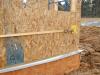 Lifting plates attached to the wall provide good bracing to tighten up SIP panel seams