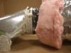 The inner liner of the flex duct is fastened to the collar with a tension tie, the connection is sealed with mastic, then the outer layer is pulled over and sealed with mastic or foil tape (Steven Winter Associates 2013).