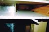 Cut-away view showing unsealed gaps around a heating duct that goes through a wall