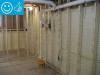Right - Closed-cell spray foam covers the interior of the foundation wall and wall framing is placed to the inside of the spray foam.