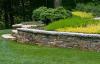 Adding planted terraces to a sloped yard can slow down runoff and reduce erosion