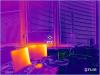 This infrared image shows little heat gain from north-facing double-pane windows with blinds, but significant heat output from computer monitors