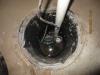 Right – A sump pump with a perforated sump pit was installed in the crawlspace slab to reduce water accumulation under the slab