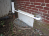 Before sealing and insulating the crawlspace, the windows were sealed, the window wells backfilled, and sumps pumps were installed that discharged to the gutter downspouts