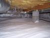 Polyethylene completely covers the floor of this crawlspace and is attached to the walls and piers as well