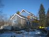 This farmhouse was retrofit by removing the existing siding and adding taped insulated sheathing and battens before installing new siding