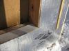 A piece of siding is used as sill extension and to provide slope in the opening for the window, which is deeper because exterior rigid foam has been added