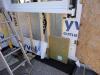 Vapor-permeable mineral wool insulation is installed on the exterior side of the sill beam during an exterior wall retrofit to allow the sill beam to dry to the outside