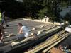Wood blocking for future PV panel installation is installed in the layers of polyisocyanurate rigid foam insulation during a flat roof retrofit