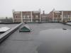 The existing flat roof before removal of membrane shows lack of slope allowing water to pool on the surface