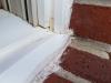 Wrong - Window sill trim was too tall for window frame and was poorly modified in an attempt to provide drainage out of the window.