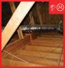 Wrong: Ducts are held from the rafters with strapping and a large beam prevents ducts from properly lying on the ceiling plane