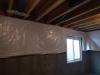 Wrong - The basement blanket insulation is loosely attached to the interior of the basement wall, does not cover the entire wall, is not sealed at the edges, and is not installed over rigid foam that covers the entire surface of the foundation walls.