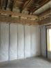 The rim joists and top plates are air sealed and insulated with open-cell spray foam while the walls are filled with blown fiberglass.