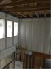 The advance-framed 2x6 24-inch on-center walls are covered with netting then filled with R-23 blown fiberglass. 