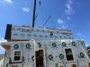 Each floor of this two-story modular home is constructed in a factory, including the 2x6, 24-inch on-center walls, R-21 fiberglass batt cavity insulation, and rigid exterior foam, housewrap, windows, and trim, then connected on site. 