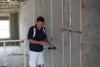 Moisture levels are checked in the blown cellulose insulation before enclosing the walls.