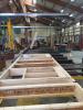 These factory-built walls consist of 9.5-inch I-studs sheathed with coated OSB, faced with OSB, and dense-packed with cellulose; a second interior surface of drywall is added to provide a 1.5-inch cavity for electrical wiring.