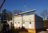The walls and floors of this modular home were constructed in a factory and are brought to the site already insulated and ready for quick assembly.