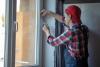 Installation of weatherstripping on a window.