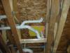 Plumbing penetrations through the subfloor are air-sealed.